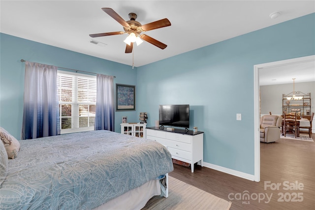 bedroom with ceiling fan and dark wood-type flooring