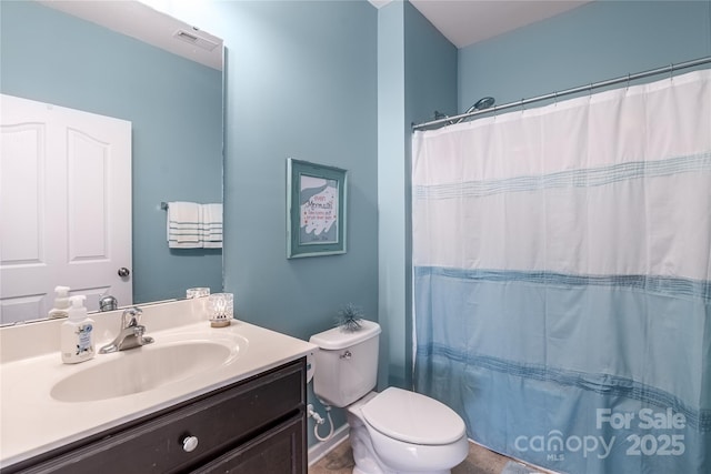 bathroom featuring vanity, toilet, and walk in shower