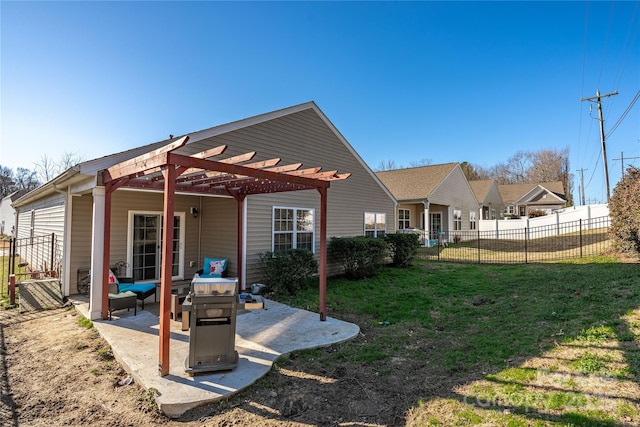 rear view of property featuring a patio, a pergola, and a lawn