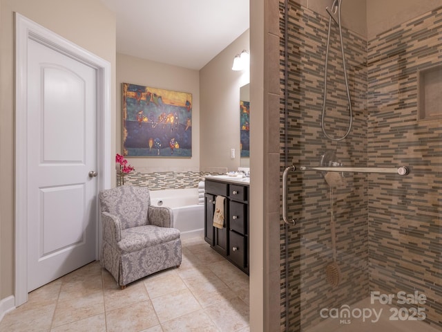 bathroom featuring tile patterned flooring, vanity, and shower with separate bathtub