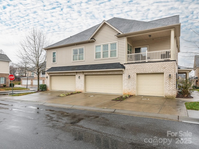 townhome / multi-family property featuring a balcony and a garage