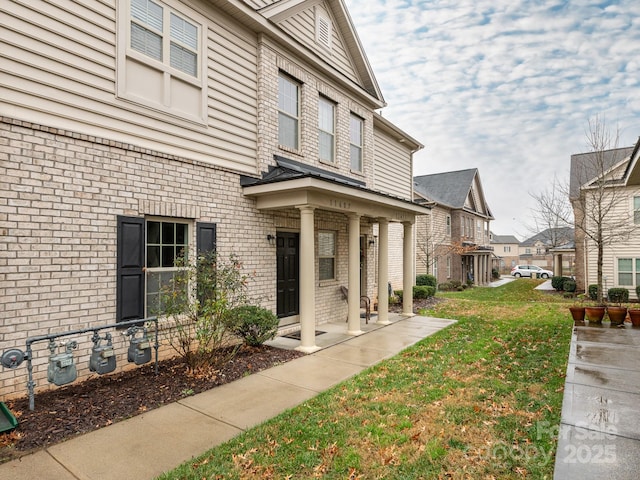 view of exterior entry with a lawn