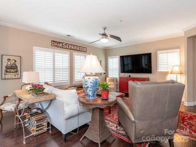 living room with dark hardwood / wood-style flooring, ceiling fan, and ornamental molding