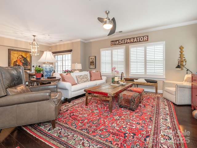 living room with dark hardwood / wood-style flooring, ceiling fan, and ornamental molding