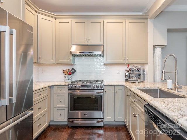 kitchen featuring sink, decorative backsplash, light stone countertops, range hood, and appliances with stainless steel finishes