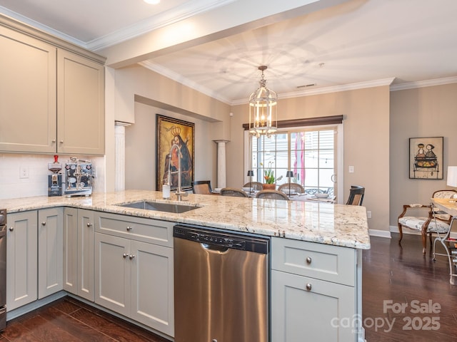 kitchen featuring dishwasher, sink, dark wood-type flooring, kitchen peninsula, and decorative light fixtures