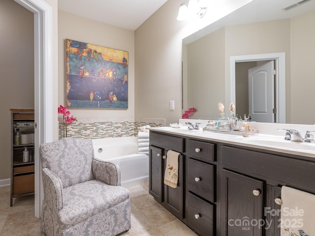 bathroom featuring tile patterned floors, vanity, and a bath