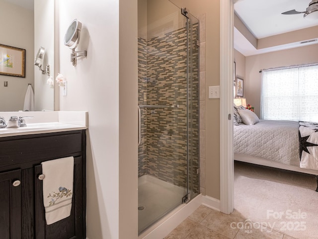 bathroom with ceiling fan, tile patterned flooring, vanity, and an enclosed shower