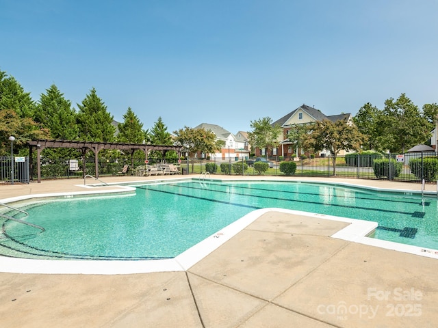 view of swimming pool with a patio and a pergola