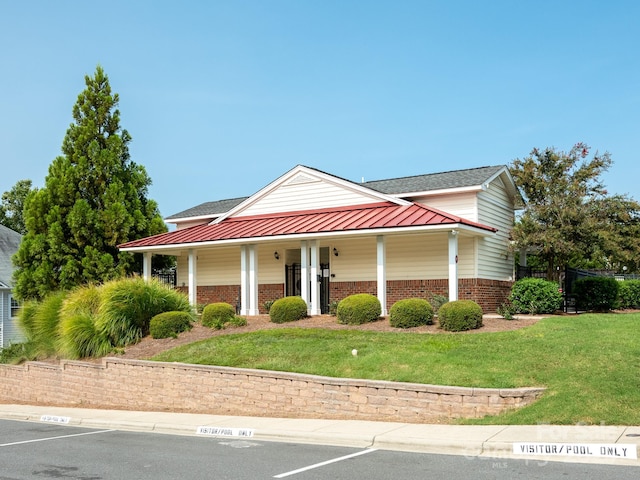 view of front of house with a porch and a front lawn