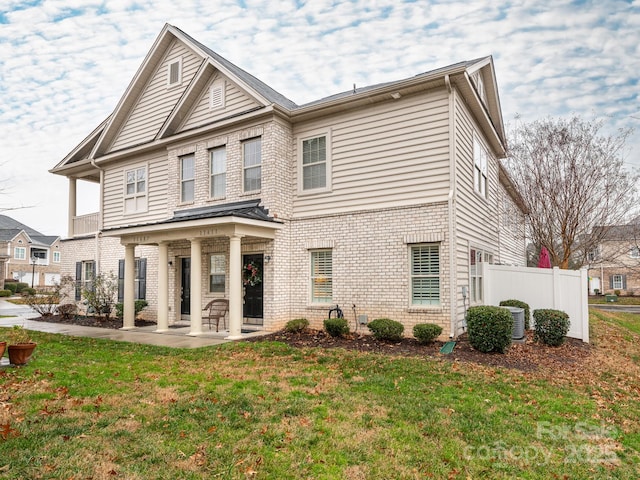 exterior space with a front yard and central AC