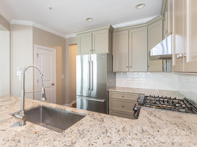 kitchen featuring ornamental molding, freestanding refrigerator, a sink, and range hood