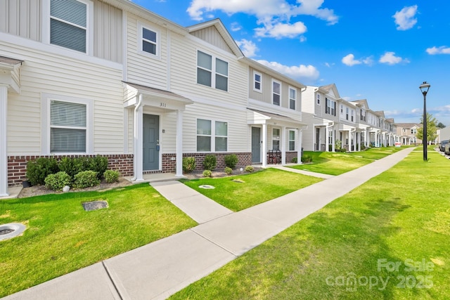 view of property featuring a front lawn