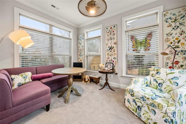 carpeted living room featuring ornamental molding and a wealth of natural light