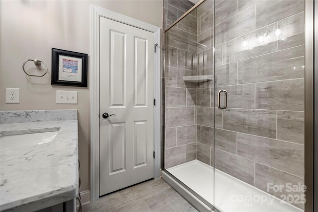 bathroom featuring vanity and a shower with shower door