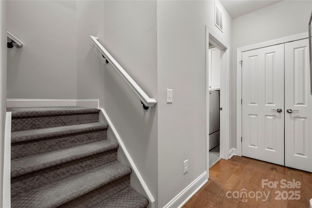 staircase with wood-type flooring