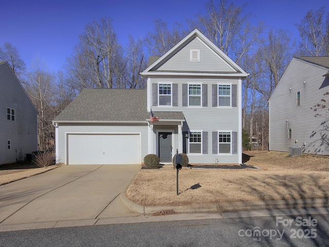 front of property featuring cooling unit and a garage