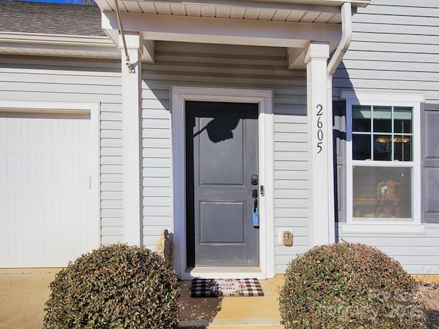 view of exterior entry with a garage