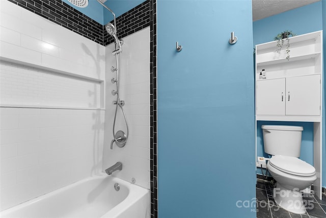 bathroom featuring toilet, a textured ceiling, and tiled shower / bath combo