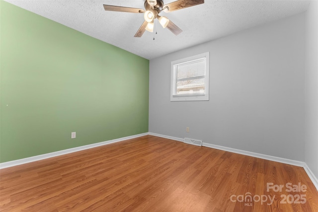 unfurnished room featuring hardwood / wood-style flooring, a textured ceiling, and ceiling fan