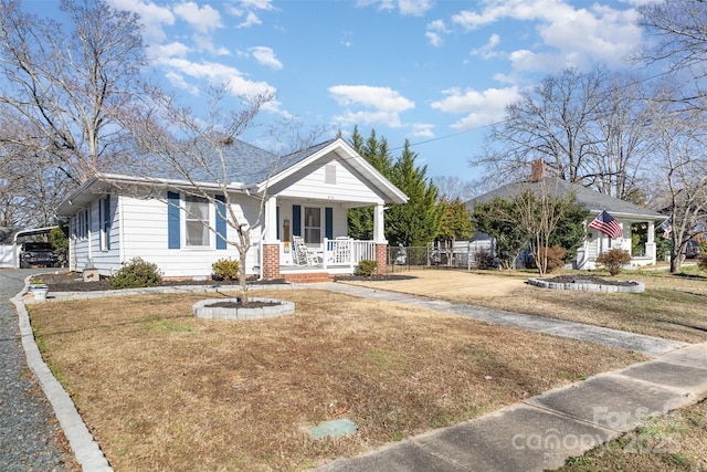 view of front of house featuring covered porch and a front yard