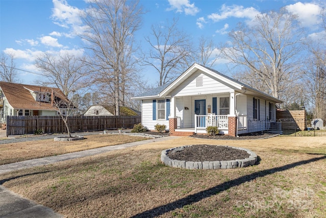 view of front of property with covered porch and a front lawn