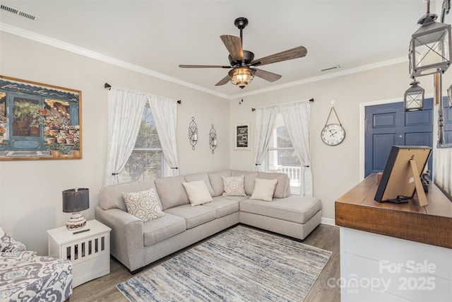 living room featuring ceiling fan, crown molding, and hardwood / wood-style flooring