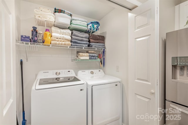 clothes washing area with washing machine and dryer