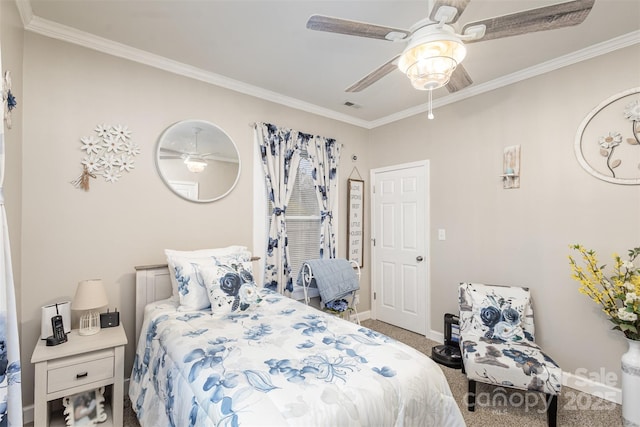 carpeted bedroom featuring ceiling fan and crown molding