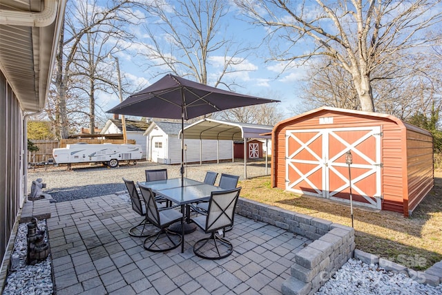 view of patio / terrace featuring a shed and a carport