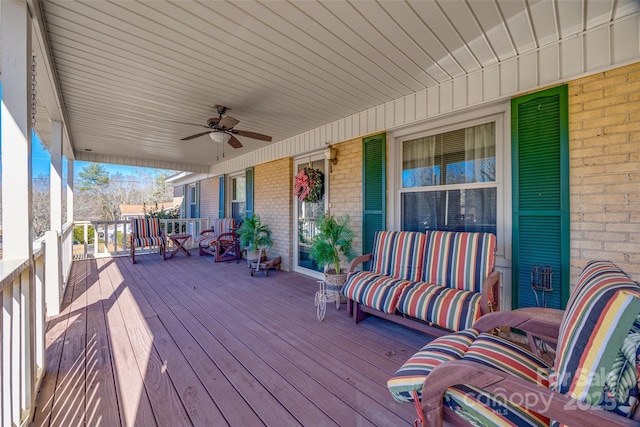 wooden terrace with a porch and ceiling fan