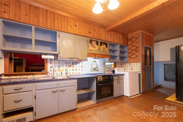 kitchen with wooden ceiling, black appliances, sink, light hardwood / wood-style floors, and washer / dryer