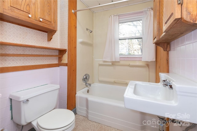 bathroom with shower / bath combination and toilet