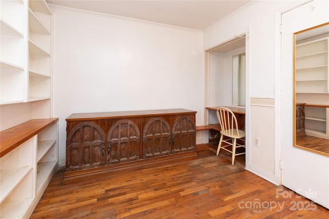 interior space with dark hardwood / wood-style flooring and crown molding