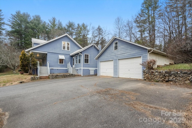 view of front of home featuring a porch and a garage