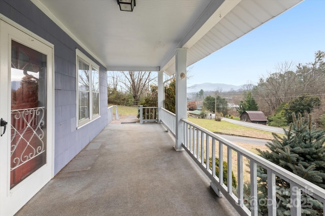 balcony with a mountain view and a porch