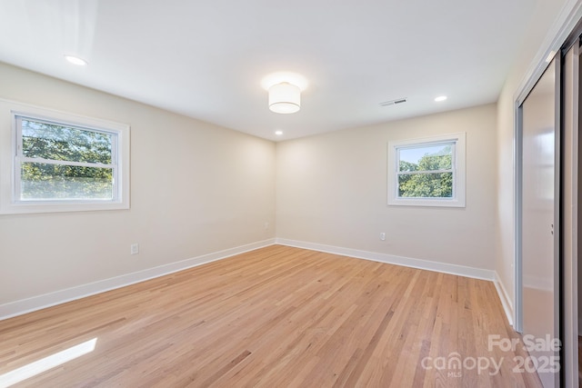 empty room with light hardwood / wood-style floors