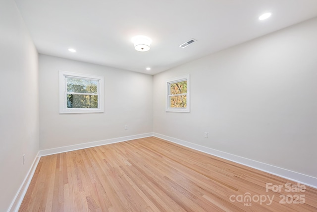 spare room featuring light hardwood / wood-style floors