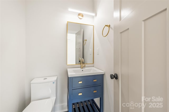 bathroom featuring vanity and toilet