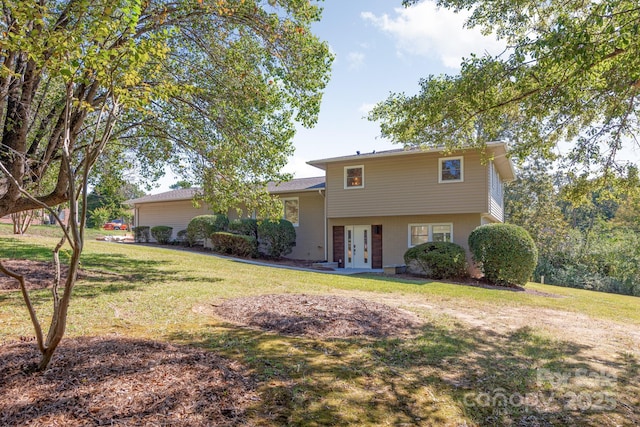 tri-level home with a front lawn