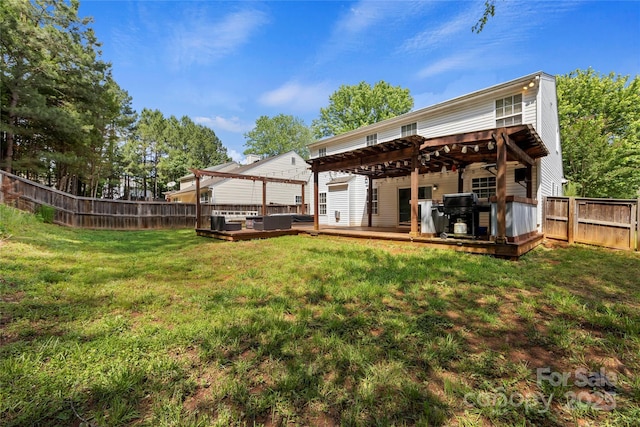 rear view of property with a pergola, a yard, and a wooden deck