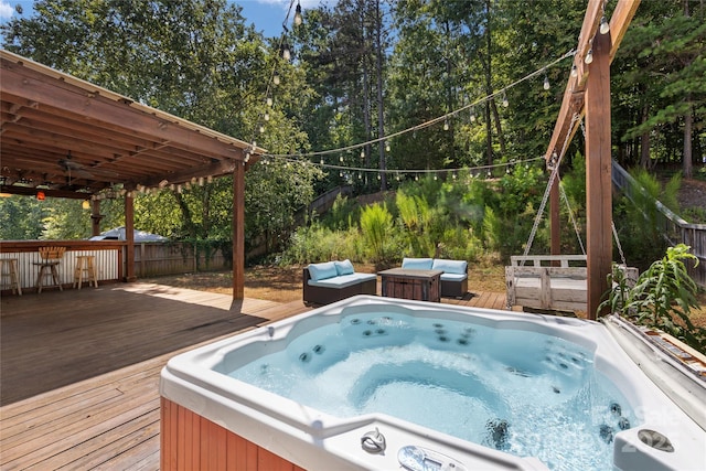 view of swimming pool with outdoor lounge area, a hot tub, and a deck