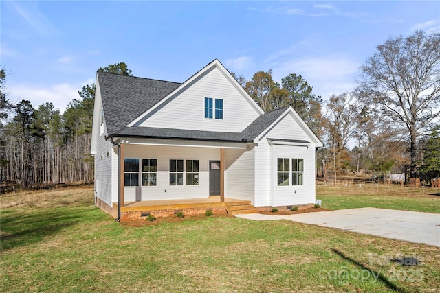 view of front of home with a front yard and a porch