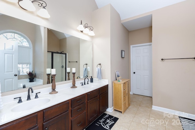 bathroom featuring tile patterned floors, vanity, and shower with separate bathtub