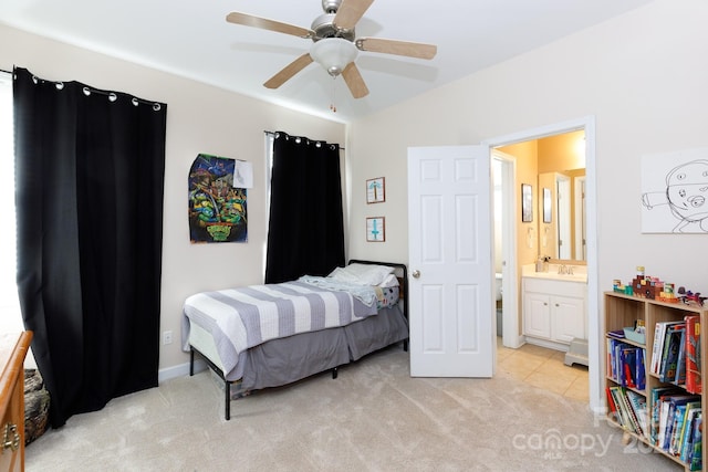 carpeted bedroom with ensuite bathroom and ceiling fan