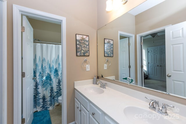 bathroom with tile patterned floors, vanity, toilet, and walk in shower