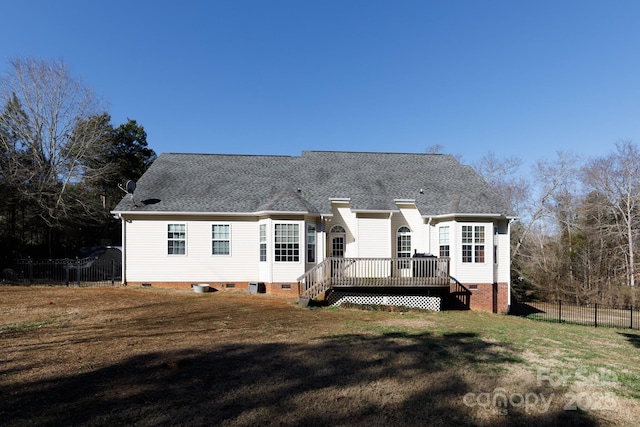 rear view of property with a deck and a yard