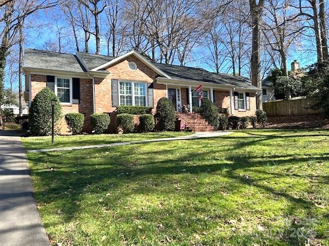 ranch-style home with a front lawn