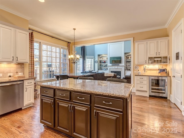 kitchen with stainless steel dishwasher, white cabinets, wine cooler, and dark brown cabinetry