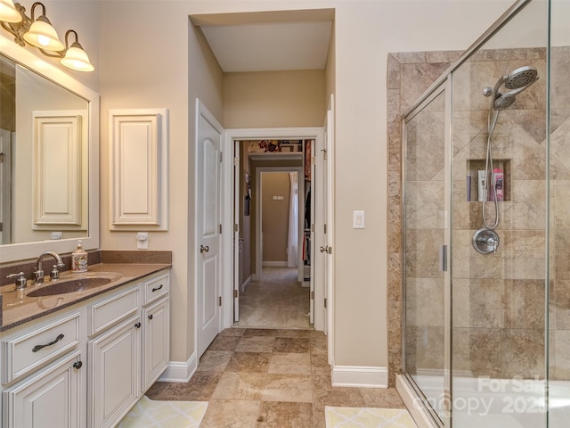 bathroom with a shower with door and vanity